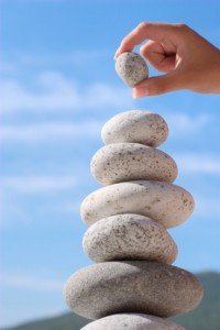 Summer. Wild beach. Someone's hand constructs equilibrium.