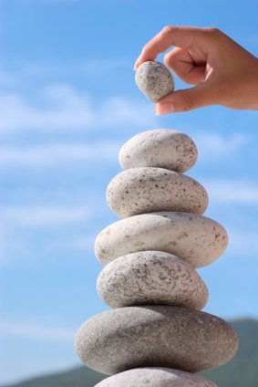 Summer. Wild beach. Someone's hand constructs equilibrium.